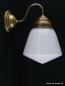 Preview: Schlichte Jugendstil Wandleuchte mit geschwungenem Arm, Material Messing - hell patiniert, Spitzzylinder opal weiß, 1xE27/40W, Spiegel-Badlampe nach unten