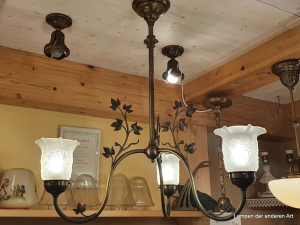 außergewöhnliche antike 3-armige Deckenleuchte aus der Zeit des Jugendstil, drei stilisierte gewundene Blütenstiele mit Blattranken aus Messing, die jeweils in einem satinierten Glasschirm, welcher ebenfalls mit Jugendstilelementen verziert ist, enden